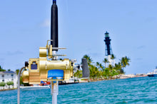 Load image into Gallery viewer, hooker electric genII mounted on Shimano tiara 50wlrsa reel on custom rod in front of light house