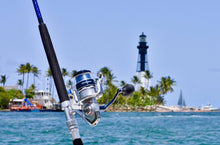Load image into Gallery viewer, Shimano Saragosa 8000 sw spinning reel on custom rod in front of light house