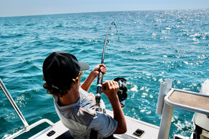 man fishing on boat in ocean