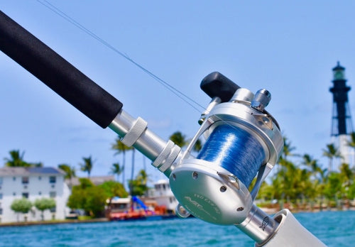 avet exw 30/2 big game reel on custom rod in front of lighthouse